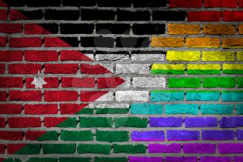 Dark brick wall texture - coutry flag and rainbow flag painted on wall - Jordan