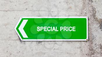 Green sign on a concrete wall - Special price