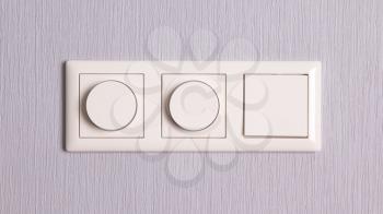 Lightswitches on a grey wall, three on a row