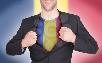 Businessman opening suit to reveal shirt with flag, Romania