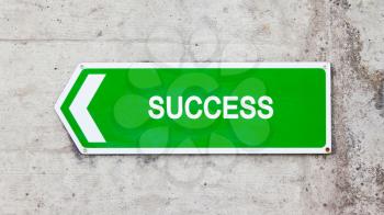 Green sign on a concrete wall - Success