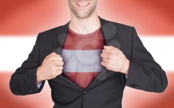 Businessman opening suit to reveal shirt with flag, Austria