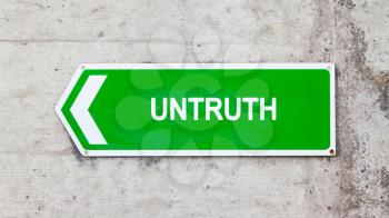 Green sign on a concrete wall - Untruth
