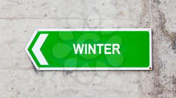 Green sign on a concrete wall - Winter