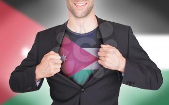 Businessman opening suit to reveal shirt with flag, Jordan