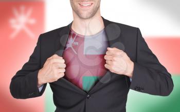 Businessman opening suit to reveal shirt with flag, Oman