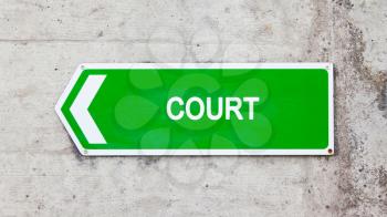 Green sign on a concrete wall - Court