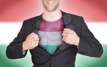 Businessman opening suit to reveal shirt with flag, Hungary
