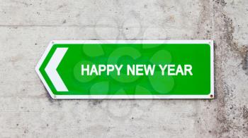 Green sign on a concrete wall - Happy new year