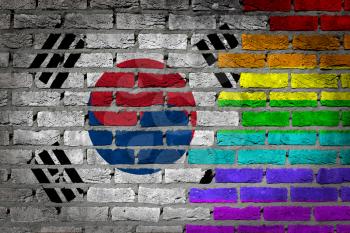 Dark brick wall texture - coutry flag and rainbow flag painted on wall - South Korea