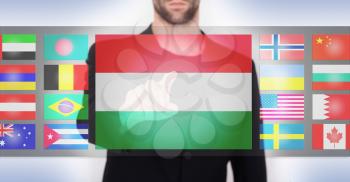 Hand pushing on a touch screen interface, choosing language or country, Hungary