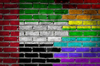 Dark brick wall texture - coutry flag and rainbow flag painted on wall - UAE