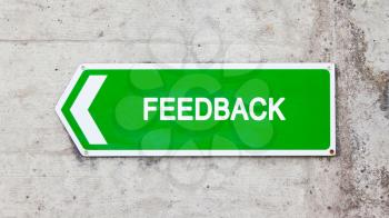 Green sign on a concrete wall - Feedback