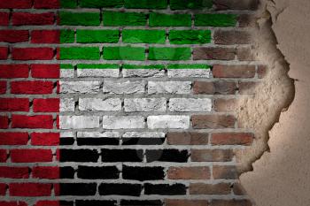 Dark brick wall texture with plaster - flag painted on wall - United Arab Emirates
