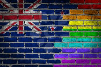 Dark brick wall texture - coutry flag and rainbow flag painted on wall - New Zealand