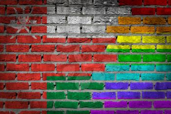 Dark brick wall texture - coutry flag and rainbow flag painted on wall - Oman