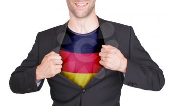 Businessman opening suit to reveal shirt with flag, Germany