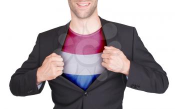 Businessman opening suit to reveal shirt with flag, the Netherlands