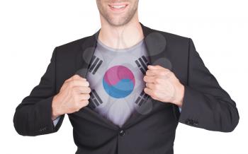 Businessman opening suit to reveal shirt with flag, South Korea