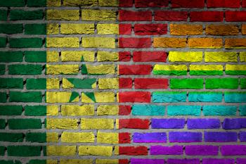 Dark brick wall texture - coutry flag and rainbow flag painted on wall - Senegal