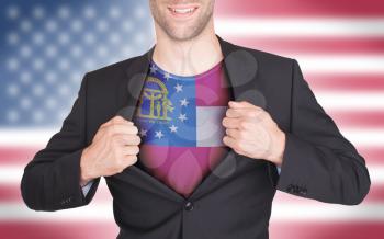 Businessman opening suit to reveal shirt with state flag (USA), Georgia