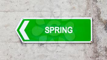 Green sign on a concrete wall - Spring