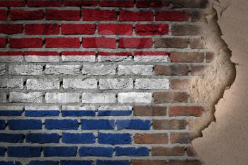 Dark brick wall texture with plaster - flag painted on wall - Netherlands
