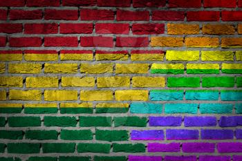 Dark brick wall texture - coutry flag and rainbow flag painted on wall - Bolivia