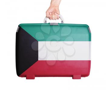 Used plastic suitcase with stains and scratches, printed with flag, Kuwait