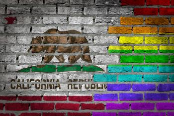 Dark brick wall texture - coutry flag and rainbow flag painted on wall - California