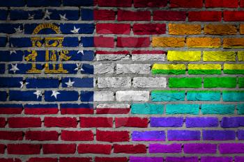 Dark brick wall texture - coutry flag and rainbow flag painted on wall - Georgia