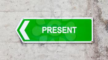 Green sign on a concrete wall - Present