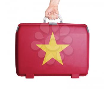 Used plastic suitcase with stains and scratches, printed with flag, Vietnam
