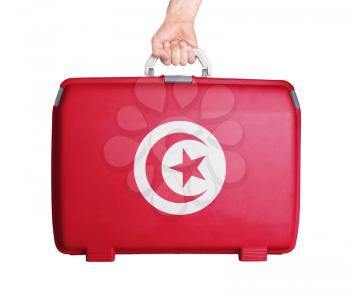 Used plastic suitcase with stains and scratches, printed with flag, Tunisia