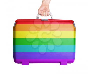Used plastic suitcase with stains and scratches, printed with flag, rainbow flag