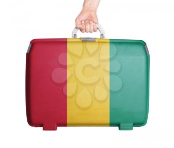 Used plastic suitcase with stains and scratches, printed with flag, Huinea