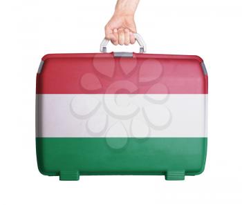 Used plastic suitcase with stains and scratches, printed with flag, Hungary
