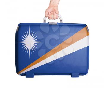 Used plastic suitcase with stains and scratches, printed with flag, Marshall Islands