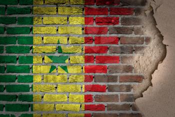 Dark brick wall texture with plaster - flag painted on wall - Senegal