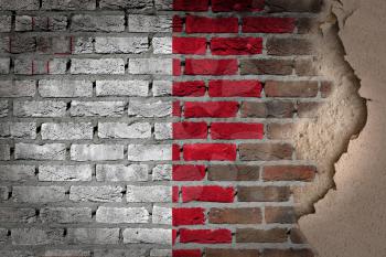 Dark brick wall texture with plaster - flag painted on wall - Malta