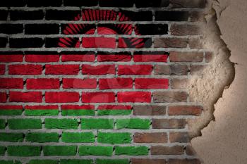 Dark brick wall texture with plaster - flag painted on wall - Malawi