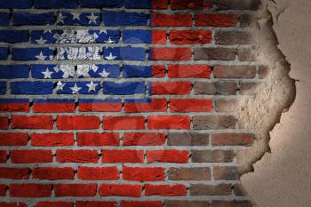 Dark brick wall texture with plaster - flag painted on wall - Myanmar