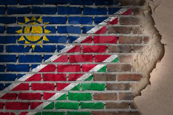 Dark brick wall texture with plaster - flag painted on wall - Namibia