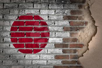 Dark brick wall texture with plaster - flag painted on wall - Japan