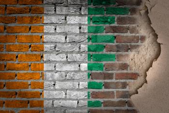 Dark brick wall texture with plaster - flag painted on wall - Ivory Coast