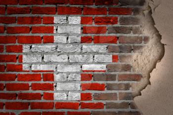 Dark brick wall texture with plaster - flag painted on wall - Switzerland