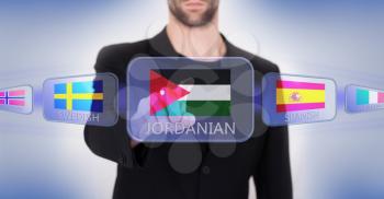 Hand pushing on a touch screen interface, choosing language or country, Jordan