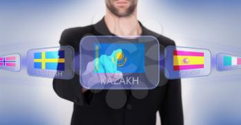 Hand pushing on a touch screen interface, choosing language or country, Kazakhstan