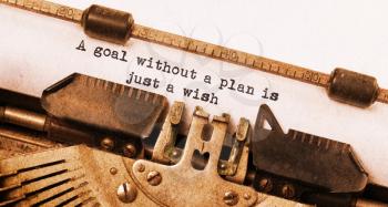 Vintage typewriter, old rusty, warm yellow filter, a goal without a plan is just a wish