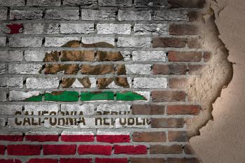 Dark brick wall texture with plaster - flag painted on wall - California